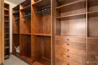 The walk-in closet showcases a handcrafted wood custom closet system, providing both functionality and elegance.