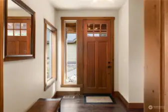 You're greeted by a warm front entry as you step through the gorgeous wood door.