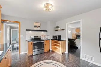 Kitchen that leads to both the living space on one side and breakfast nook, basement and dining room on the other.