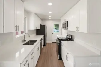 Kitchen facing South with all new appliances, sink, cabinets, & quartz countertops