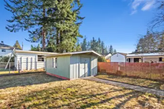 Included shed contains cabinets, workbench & shelving for gardening and storage needs