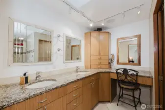 Indulge in the spacious primary bathroom featuring sleek granite countertops, abundant lighting, and generous storage—where everyday convenience is blended with a beautifully-designed retreat.