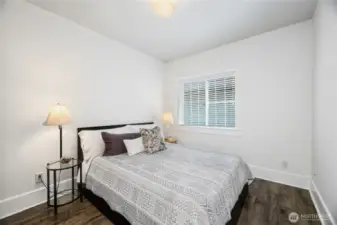 3rd Bedroom shown with Queen Size Bed has mirrored closet doors. It is just across from a bathroom and other bedroom.