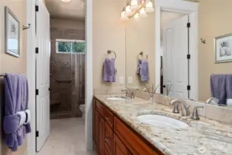 Hall bath with double sinks, tile shower