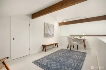 Upstairs loft makes a perfect office space, craft room or exercise area. Door goes into a large storage area!