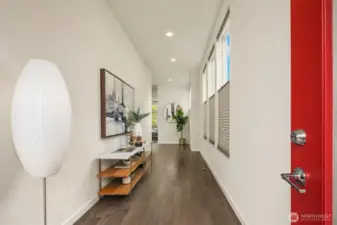 Entry gallery hallway leads to the open main floor living space.