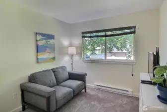 Cozy 3rd bedroom featuring soft natural light, custom blinds, and a spacious closet to keep things tidy.