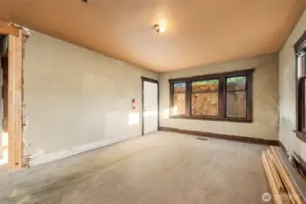 Living room features hardwood floors and classic window trim.