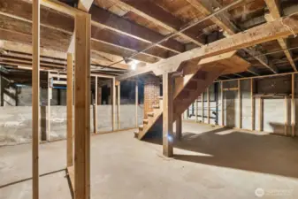 Downstairs provides flexible space for finishing as a bedroom, hobby room, or workshop.
