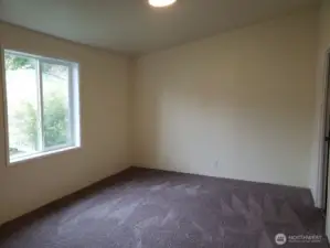 Spacious Primary Master Bedroom with Vaulted Ceiling and Newer Interior Paint and Carpet.