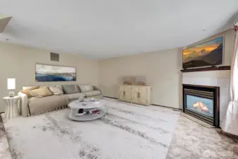 Family room off the kitchen. This room will accommodate sofas, love seats, tables, recliners and more.   Virtually staged.