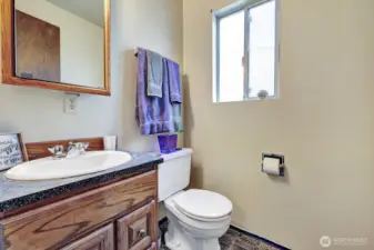 Half bath on the main floor off the utility room for your convenience. Steps to the garage door access and to the front and side yards.