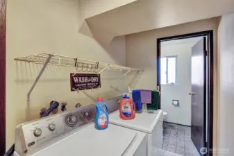 Utility room off the family room with access to the half bath and the access door to the garage.