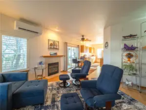 Living room with propane fireplace, MiniSplit, to dining room with galley kitchen