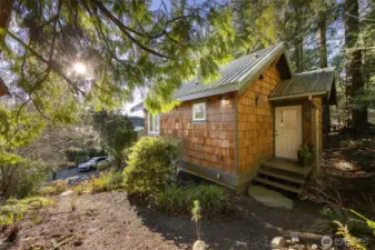The natural setting allows for easy maintenance and there is a welcoming porch.