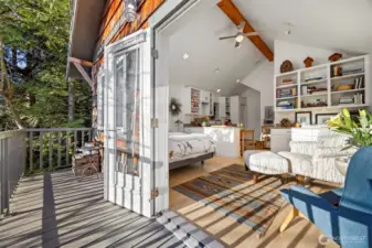 Looking to the living area from the deck through the French doors that are open wide.