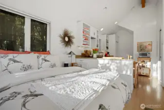 Looking across the sleeping area with the kitchen beyond.