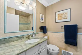 Remodeled 3/4 Bath off the Entry level with Travertine Tile finishes and heated floors.