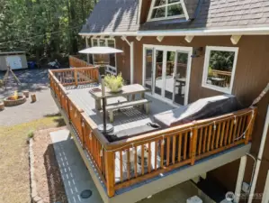 View from above of the large deck off the kitchen! There is a also a lower cement patio where the hot tub is located. It's currently not working, but can be repaired.