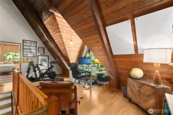 On the upper level is a loft-style office that overlooks the main living space below—perfect for remote work, study, or creative pursuits.