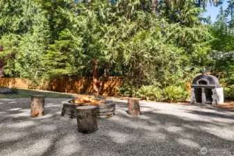 Nestled just beyond the deck is a custom fire pit area, where laughter and storytelling under the stars become part of your everyday life. But the real showstopper? Your very own gourmet pizza oven, ideal for homemade wood-fired creations and unforgettable evenings with friends.