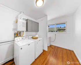 Large Laundry room with additional space that could be a great future half bath.