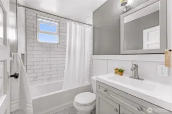 Upstairs bathroom with custom tile surround and floor.
