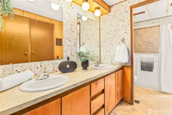 Primary bathroom with double sinks and walk in closet.