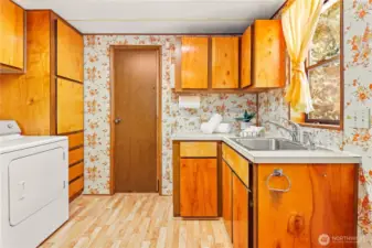Laundry room with storage and wash sink.