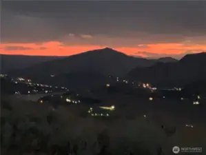 Sparkling Horizon-Beyond the ridgeline, faint lights twinkle in the valley below—enchanting evenings await