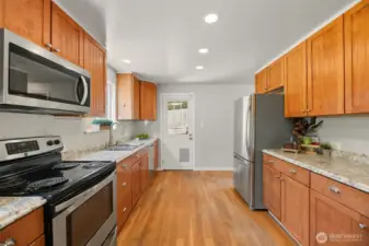 Galley Style Kitchen - Back door to covered patio and back yard