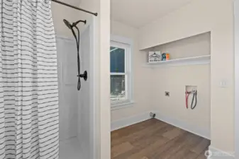 Main floor 2nd bath has step in shower and a large laundry room off the bath