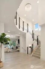 Two story entry featuring Onsite custom built metal and tempered glass railing