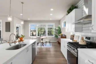 Carefully selected finishes include high end Belmont cabinets with white subway tile backsplash and white quartz counters that provide a base for the meals that will be enjoyed here.