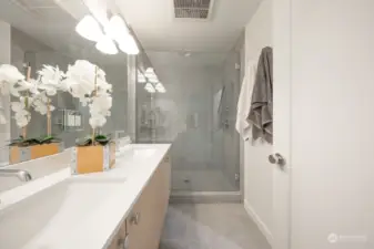 Prime bath with large walk in shower and double vanity with quartz slab countertop