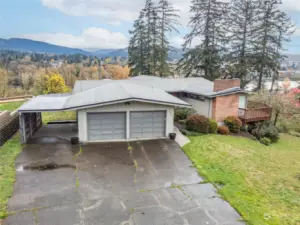 Slight aeriel view, showing off large driveway and attached Carport