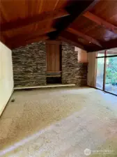 Living room with rock wall fireplace