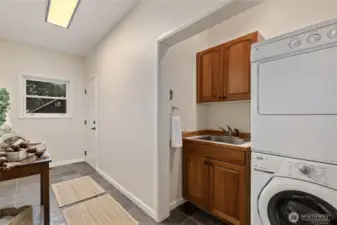 Main floor laundry/mud room/drop zone that leads out to the hot tub.