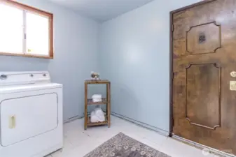Utility room with a second backyard access door nearest to the detached garage.