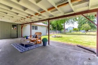 Fire pit behind the covered patio.