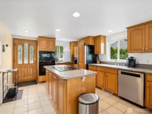 Gorgeous Kitchen w/ view, large Island, lots of counter space & storage galore with so many cabinets.
