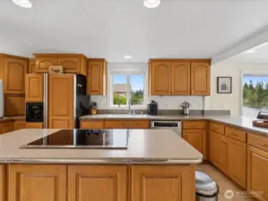 Gorgeous Kitchen w/ view, large Island, lots of counter space & storage galore with so many cabinets.