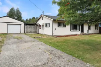Large detached garage offers plenty of room for vehicles, storage, or a workshop.