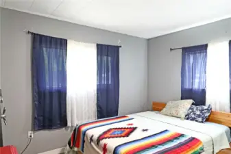 Light-filled bedroom with a peaceful feel and plenty of room to unwind.