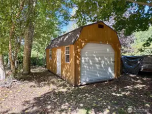 First of two outbuildings, a new large shed built on a concrete slab.