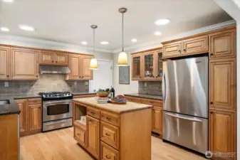 Gourmet kitchen with island and stainless steel appliances