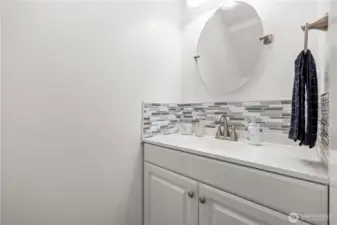 The first-floor bathroom is conveniently located for guests, complete with updated cabinets and countertops. Easy access from the main level makes it both practical and stylish.