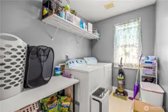 The full-size laundry room offers space for a washer and dryer along with room to build out additional storage if desired. Whether left as-is or customized, it’s a functional and flexible area.