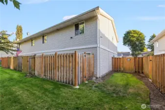 Step outside to a green backyard space with your own private patio. Perfect for entertaining, this area includes a gate that leads out back while keeping the patio fully enclosed for privacy.