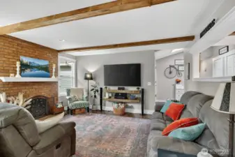 Living room with beams & brick fireplace.
